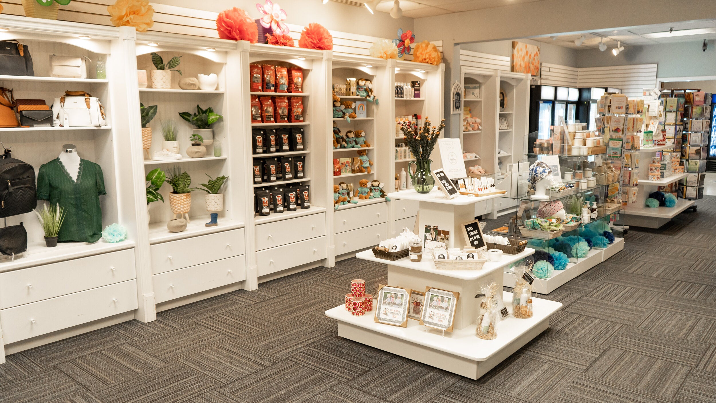 Brighten Group Gift Shop shelves with gift baskets, cards, and everyday items